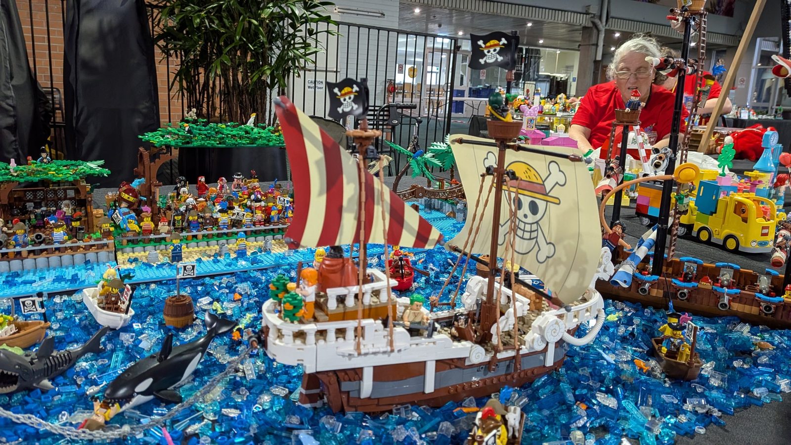 A One Piece pirate ship sailing on a sea of blue translucent bricks